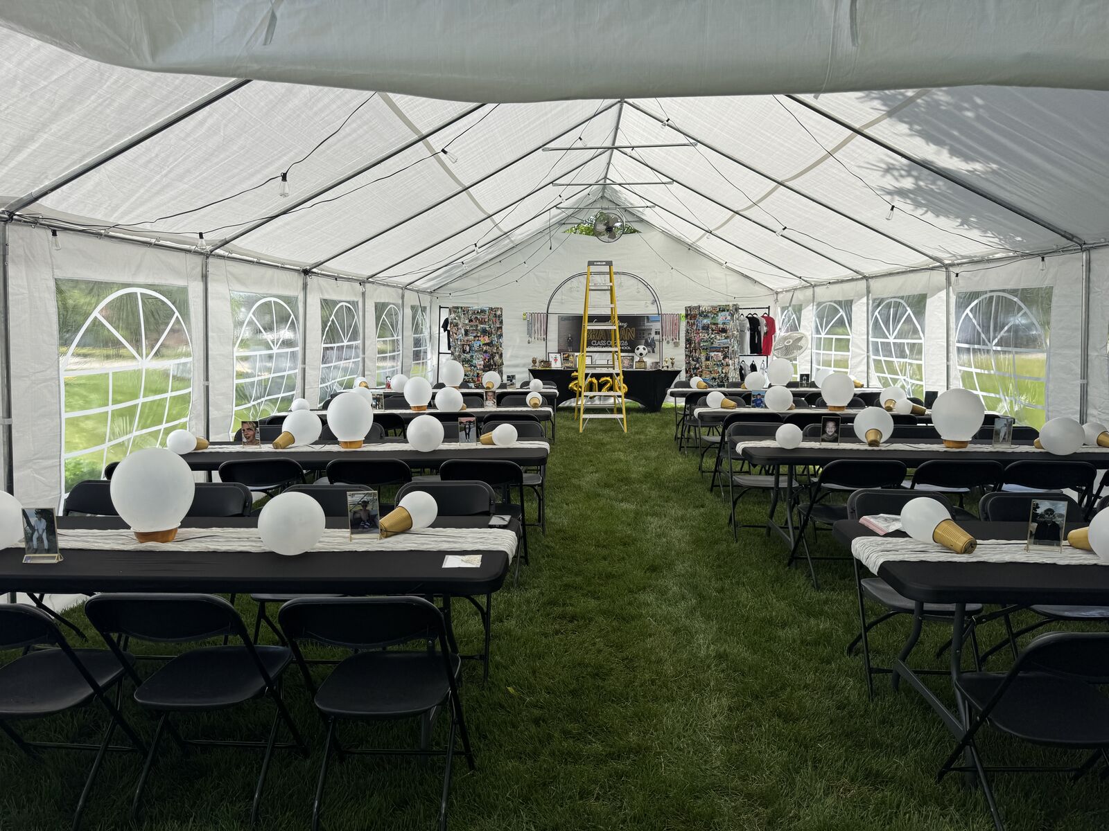 Graduation party set up inside the event tent with tables, chairs, and centerpieces