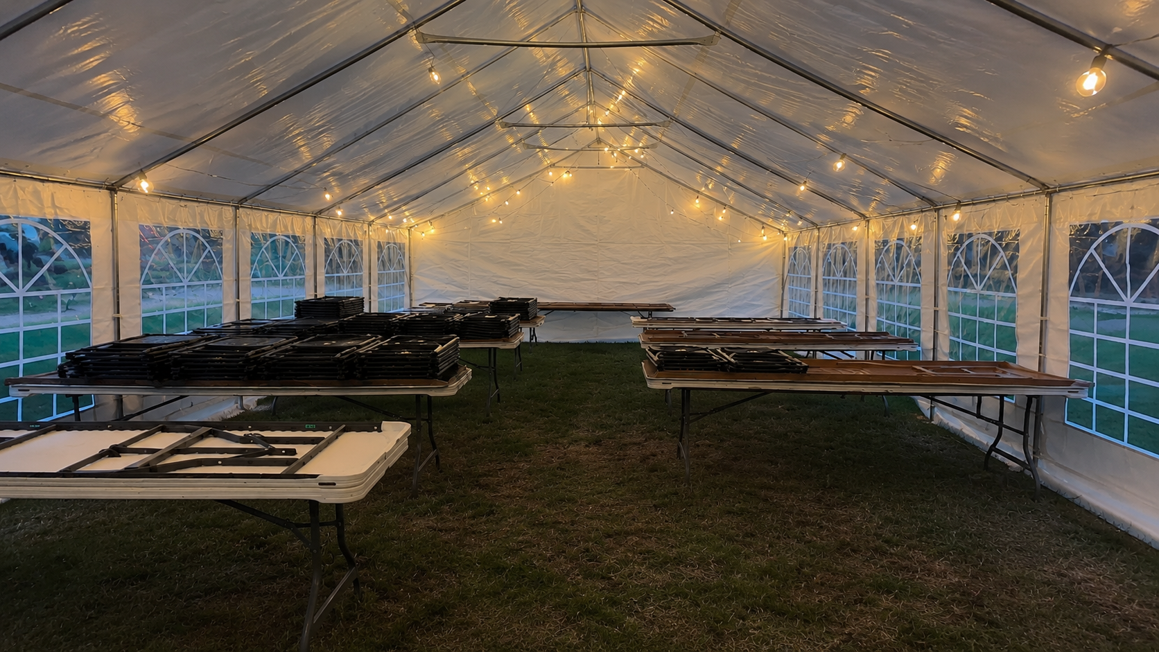 Interior of a lighted event tent with tables